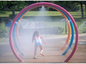 Swimming pools and splash pads are welcome fun for kids like Anna during this heatwave, seen here in Pincourt on Monday.