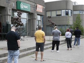 Customers wait in line at an SQDC store in 2020.