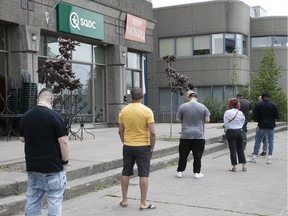 Customers wait in line  at an SQDC store in 2020.