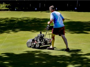 Mower Chris Morrin cuts the grass at the Westmount Lawn Bowling Club in Montreal Thursday June 10, 2021.