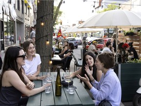 Lea, from left to right, Marine, Alexandra and Daniela enjoy the terrasse at Little Italy's Ratafia wine bar on Friday. Montrealers have once again fallen in love with the outdoors, Josh Freed writes.