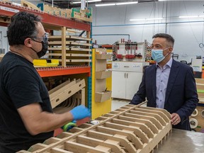 Mario Sévigny, co-founder and executive vice-president of Groupe MSB, chats with assembler Michael Miranda, left, in the company's Boucherville plant on Monday. The Bombardier supplier is expanding its production to bet on a recovery of the business aviation market.