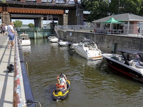 Boats of various sizes wait to go through the lock in Ste-Anne-de-Bellevue, west of Montreal on June 12, 2021.