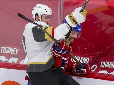 Canadiens' Shea Weber slides under check by Vegas Golden Knights Nicolas Roy during the first period of the National Hockey League playoff game in Montreal on Friday, June 18, 2021.