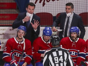 Canadiens assistant coach Luke Richardson speaks with linesman Brian Pancich while fellow assistant coach Alex Burrows looks on from behind bench during Game 3 of Stanley Cup semifinal series against the Vegas Golden Knights at the Bell Centre.