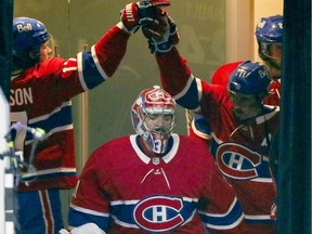 Montreal Canadiens Josh Anderson, left, high fives Brendan Gallagher as goalie Carey Price leads his team onto the ice for Game 3 of the playoffs against the Vegas Golden Knights in Montreal on June 18, 2021. It went downhill after that series.