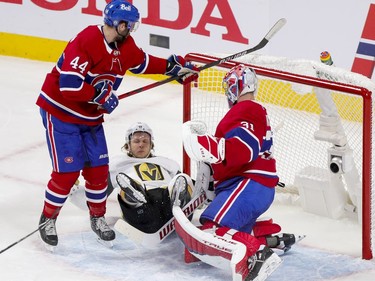 Canadiens' defenceman Joel Edmundson checks Vegas Golden Knights' William Karlsson next to goalie Carey Price during the first period of the National Hockey League playoff game in Montreal on Friday, June 18, 2021.