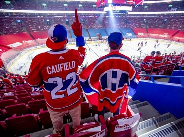 Canadiens fans and brothers Jordan, left, and Jeff Bradley from London, Ont., watch warmups prior to the Habs playoff game against the Vegas Golden Knights in Montreal on Friday, June 18, 2021.