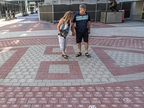 Habs fans Sophie Agnard and her husband Philippe Robert eventually found their three bricks outside the Bell Centre in Montreal on Saturday June 19, 2021. Dave Sidaway / Montreal Gazette ORG XMIT: 66315
