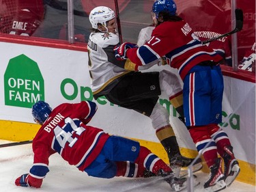 Canadiens' Paul Byron (41) and right wing Josh Anderson (17) check Vegas Golden Knights defenceman Zach Whitecloud (2) along the boards during second period NHL Stanley Cup semifinal action at the Bell Centre in Montreal on Sunday, June 20, 2021.