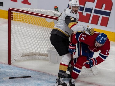 Canadiens centre Nick Suzuki (14) is checked by Vegas Golden Knights defenceman Peter DiLiberatore (3) in front of the Vegas net during late second period NHL Stanley Cup semifinal action at the Bell Centre in Montreal on Sunday, June 20, 2021.