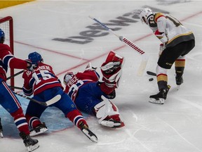 The stick of Montreal Canadiens goaltender Carey Price (31) went flying as Vegas Golden Knights center Nicolas Roy (10) held on to the puck until he had a clean scoring shot at the net during NHL Stanley Cup Semifinal overtime action at the Bell Centre in Montreal on Sunday June 20, 2021.