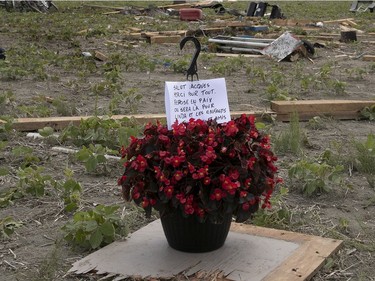 Flowers pay tribute at the location of where the remains of Jacques Lefebvre were found in Mascouche after a tornado touched down in the neighbourhood the day before.