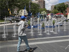 Montrealers walk along Quartiers des Spectacles at the reopening of tourism in Montreal during on Wednesday June 23, 2021.