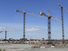Cranes crowd the skyline above the Royalmount development project at the intersection of Highway 40 and the Décarie Expressway in Montreal on Thursday, June 24, 2021.