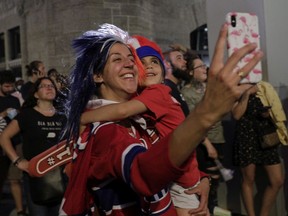 Melanie Manna and daughter Serafina enjoy the fireworks set off in front of the Bell Centre Thursday night after the Canadiens earned a berth in the Stanley Cup final.