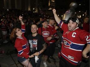 Montreal Canadiens fans celebrate in front of the Bell Centre after the Montreal Canadiens defeated the Vegas Golden Knights in Montreal Thursday, June 24, 2021 in game 6 of the third round of the NHL playoff series.
