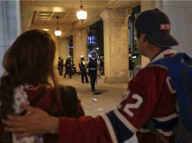 Montreal Canadiens fans watch police in downtown Montreal after the Habs defeated the Vegas Golden Knights June 24, 2021.