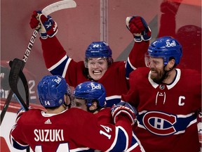 Canadiens'  Cole Caufield, centre, celebrates with teammates Nick Suzuki, Brendan Gallagher and Shea Weber, right, after beating the Vegas Golden Knights in Game 6 to advance to the Stanley Cup final.