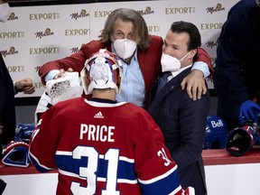 Canadiens general manager Marc Bergevin hugs goalie Carey Price and assistant coach Luke Richardson after a 3-2 overtime win over the Vegas Golden Knights in Game 6 of the semifinal series June 24 at the Bell Centre.