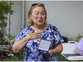 Former Baie-D'Urfé mayor Maria Turino gives a speech after receiving the medal of the National Assembly from Jacques-Cartier MNA Greg Kelley, on Monday, June 28.