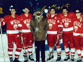 Jay McMullan (left to right), Mike Babcock, Ken Tyler (head coach), Paul Barber, Doug Harrison and Alan Crawford pose during a stoppage in play to clear snow off outdoor rink at St. Moritz, Switzerland, Dec. 1983