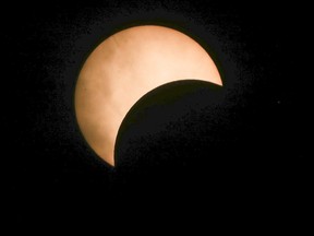 Partial solar eclipse seen from outside the Rio Tinto Alcan Planetarium in Montreal Monday August 21, 2017.