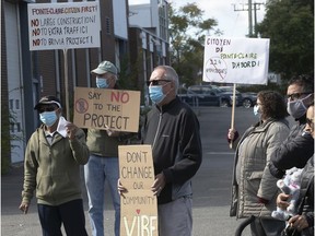 Protesters show their displeasure to a proposed high-density residential project on St-Jean Blvd. just south of Hymus Blvd., on Sept. 19, 2020. This week, Pointe-Claire city council voted down the project.