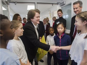 Ann Marie Matheson shakes hands with student Cecilia Samayoa after she and other students presented her with a thank you card in the hallway outside one of four modular classrooms in December 209 that had been installed in Edinburgh school to address overcrowding issues.