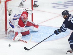 Canadiens' Carey Price  makes a save as Mathieu Perreault of the Winnipeg Jets looks for a rebound in Game 2 of the second round of the 2021 Stanley Cup Playoffs on Friday, June 4, 2021, at Bell MTS Place in Winnipeg.