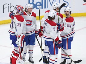 Canadiens players congratulate goalie Carey Price after he made 30 saves in 1-0 win over the Jets in Game 2 of North Division final Friday night in Winnipeg.