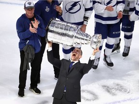 Tampa Bay Lightning general manager Julien BriseBois, a native of Greenfield Park, hoists the Stanley Cup after beating the Dallas Stars in 2020 final.