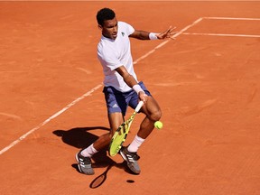 Félix Auger-Aliassime plays a forehand in first-round match against Andreas Seppi of Italy on Day 3 of the 2021 French Open at Roland Garros on June 1, 2021 in Paris, France.