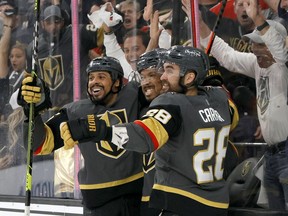 The Vegas Golden Knights’ Ryan Reaves (75), Keegan Kolesar (55) and William Carrier (28) celebrate after Kolesar’s second-period goal in Game 6 of West Division final against the Colorado Avalanche on Thursday night.