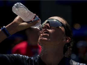 Triathlete Jackie Hering stays hydrated at an event in June in Des Moines, Iowa. Drinking cold water or a slurry of ice and water can help with the mental challenge of working out in the heat, Jill Barker writes, but be careful to avoid a brain freeze or upset stomach.