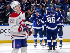 Lightning players celebrate a goal as the Canadiens' Cole Caufield looks on in frustration during Game 1 of the Stanley Cup final Monday night in Tampa.