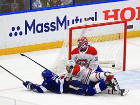 Lightning's Blake Coleman dives past Phil Danault and beats goalie Carey Price for a goal with 0.3 seconds left in the second period Wednesday night in Tampa.
