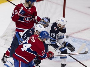 Canadiens' Corey Perry (94) completes a wrap around to score against Winnipeg Jets goaltender Connor Hellebuyck during round two, Game 3 NHL playoff action in Montreal on Sunday, June 6, 2021.