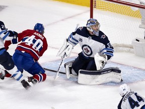 Winnipeg Jets goaltender Connor Hellebuyck (37) looks over to see Montreal Canadiens right wing Joel Armia (40) short handed goal during round 2, game 3 NHL playoff action in Montreal on Sunday, June 6, 2021.