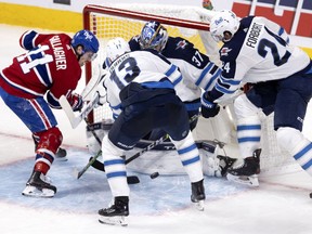 MONTREAL, QUE.: June 6, 2021 -- Montreal Canadiens right wing Brendan Gallagher (11) tries for the rebound from Winnipeg Jets goaltender Connor Hellebuyck (37) as Winnipeg Jets center Pierre-Luc Dubois (13) and Winnipeg Jets defenseman Derek Forbort (24) Try to clear the puck during round 2, game 3 NHL playoff action in Montreal on Sunday, June 6, 2021. (Allen McInnis / MONTREAL GAZETTE)