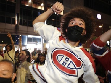 Canadiens fans celebrate a second period goal outside the Bell Centre for Game 4 of the third round of the NHL playoff series between Montreal the Vegas Golden Knights in Montreal on Sunday, June 20, 2021.