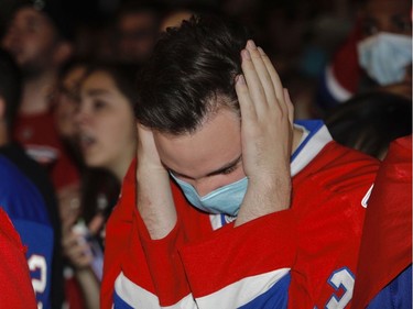 A Canadiens fan shows emotion after the Vegas Golden Knights tied the score in the third period while watching the game from outside the Bell Centre for Game 4 of the third round of the NHL playoff series between the Canadiens and the Vegas Golden Knights in Montreal on Sunday, June 20, 2021.