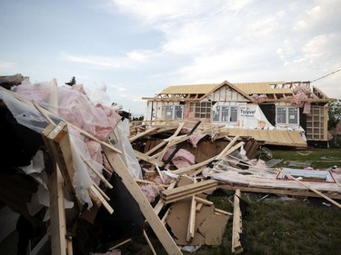 The home of Mathieu Hamel and Laurence Barbe sits in the backyard after being ripped from its moorings after a tornado struck in Mascouche north of Montreal on Monday, June 21, 2021.