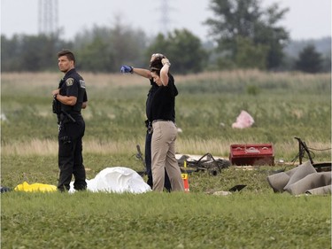 Police investigate the scene where a man was discovered after a tornado struck in Mascouche north of Montreal on Monday, June 21, 2021. Neighbours said the tornado came so quickly, he tried to take shelter in a shed.