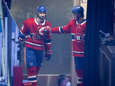 Montreal Canadiens Phillip Danault (24) and  Jesperi Kotkaniemi (15) wait for the queue to hit the ice for the pregame warmup skate during NHL semi final game 6 against the Vegas Golden Knights in Montreal on Thursday, June 24, 2021.