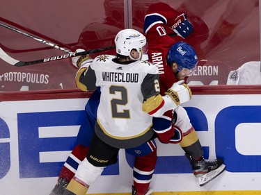 Joel Armia (40) gets pinned to the boards by Vegas Golden Knights defenseman Zach Whitecloud (2) during NHL semi final game 6  in Montreal on Thursday, June 24, 2021.