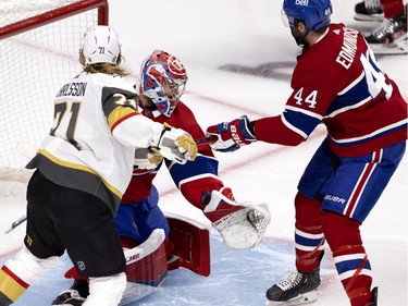 Carey Price (31) stops Vegas Golden Knights center William Karlsson (71) as Montreal Canadiens defenseman Joel Edmundson (44) tries to keep Karlsson away from Price during NHL semi final game 6  in Montreal on Thursday, June 24, 2021.