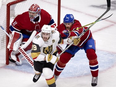 Jon Merrill (28) clears Vegas Golden Knights right wing Reilly Smith (19) from the front of Montreal Canadiens goaltender Carey Price (31) goal crease during NHL semi final game 6 in Montreal on Thursday, June 24, 2021.
