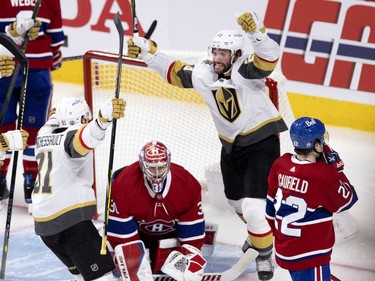 Vegas Golden Knights defenseman Alec Martinez (23), right, and Jonathan Marchessault (81) celebrate scoring against Carey Price (31) to tie the game 2-2 during NHL semi final game 6 in Montreal on Thursday, June 24, 2021.