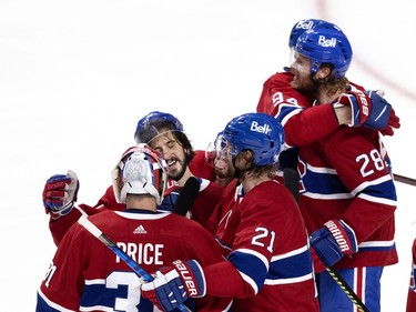 Phillip Danault (24) congratulates Carey Price (31) and Eric Staal (21) after defeating the Vegas Golden Knights during NHL semi final game 6  in Montreal on Thursday, June 24, 2021.